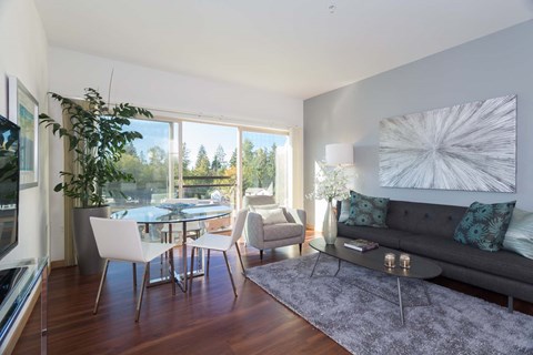 a living room and dining room with a table and a couch